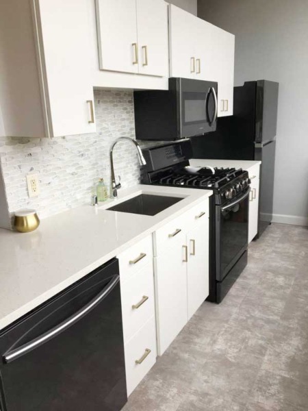 Stylish kitchen with black appliances and white cabinets in Greenfield, WI