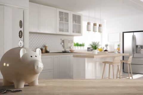 A piggy bank on a table in a remodeled kitchen by We Do Kitchens 2