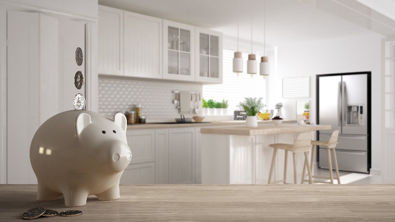 A piggy bank on a table in a remodeled kitchen by We Do Kitchens 2